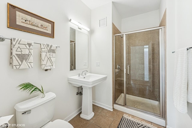 757 N Orleans St Unit 711, Chicago, IL 60654 - bathroom with toilet, tile patterned floors, baseboards, and a shower stall