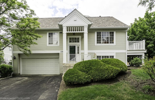 150 Lucerne Ct Unit 150, Wheeling, IL 60090 - raised ranch with driveway, an attached garage, a shingled roof, and a balcony