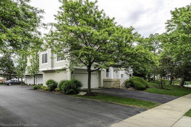 150 Lucerne Ct Unit 150, Wheeling, IL 60090 - view of side of property with asphalt driveway and a garage