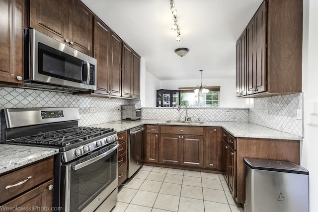 150 Lucerne Ct Unit 150, Wheeling, IL 60090 - kitchen with stainless steel appliances, a sink, light tile patterned floors, and backsplash