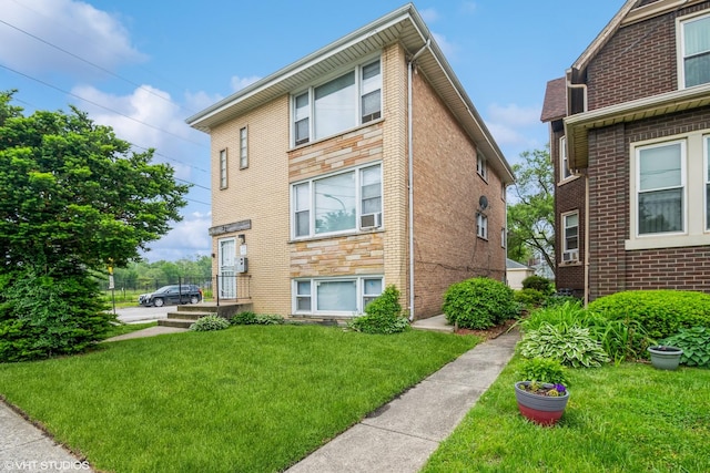 32 E 137th St, Riverdale, IL 60827 - view of property exterior with a lawn, brick siding, and cooling unit