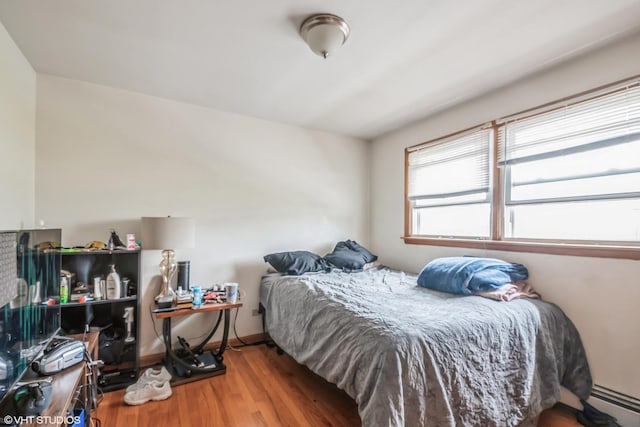 32 E 137th St, Riverdale, IL 60827 - bedroom featuring wood finished floors, a baseboard heating unit, and baseboards