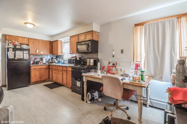 32 E 137th St, Riverdale, IL 60827 - kitchen with black appliances, an office area, brown cabinetry, and baseboard heating