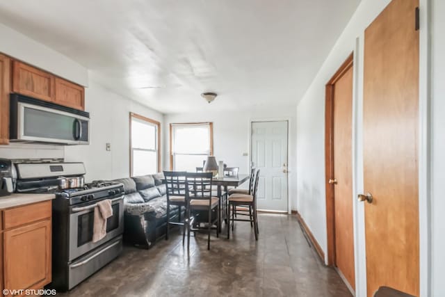 32 E 137th St, Riverdale, IL 60827 - kitchen with appliances with stainless steel finishes, concrete floors, brown cabinets, light countertops, and baseboards