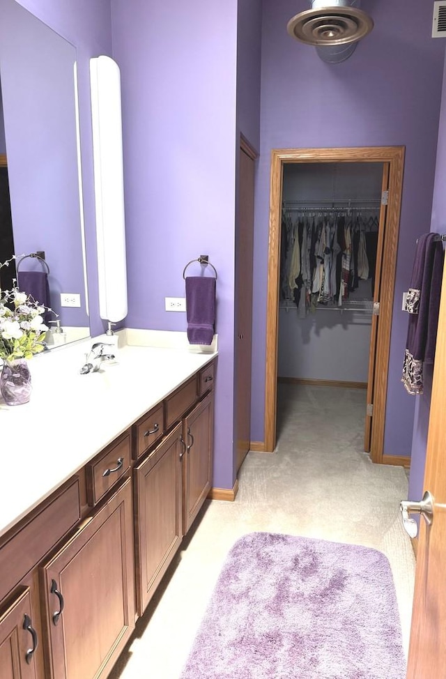 1716 Simms St Unit 0, Aurora, IL 60504 - bathroom featuring vanity, baseboards, and a walk in closet