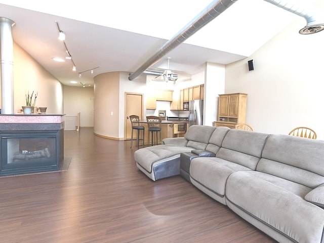 1716 Simms St Unit 0, Aurora, IL 60504 - living room featuring dark wood-style flooring, rail lighting, and a glass covered fireplace