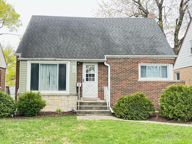 1474 Forest Ave, Calumet City, IL 60409 - view of front of home with a shingled roof, a front lawn, brick siding, and a chimney