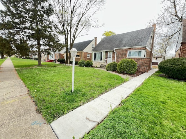 1474 Forest Ave, Calumet City, IL 60409 - view of front of home featuring brick siding, a front lawn, roof with shingles, and a chimney