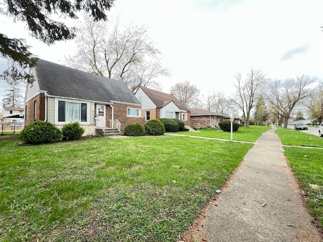 1474 Forest Ave, Calumet City, IL 60409 - view of front facade featuring brick siding, a front lawn, and a shingled roof
