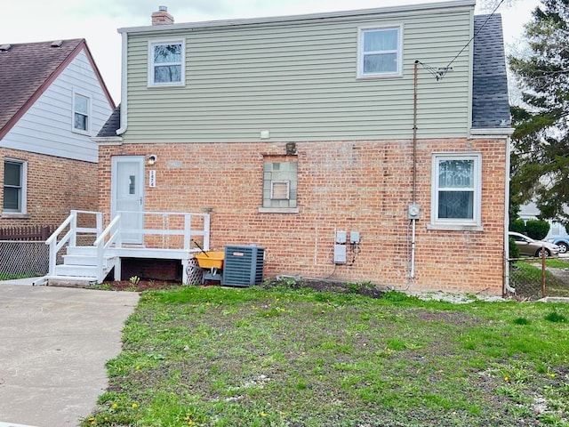 1474 Forest Ave, Calumet City, IL 60409 - back of house featuring brick siding, central air condition unit, and a chimney