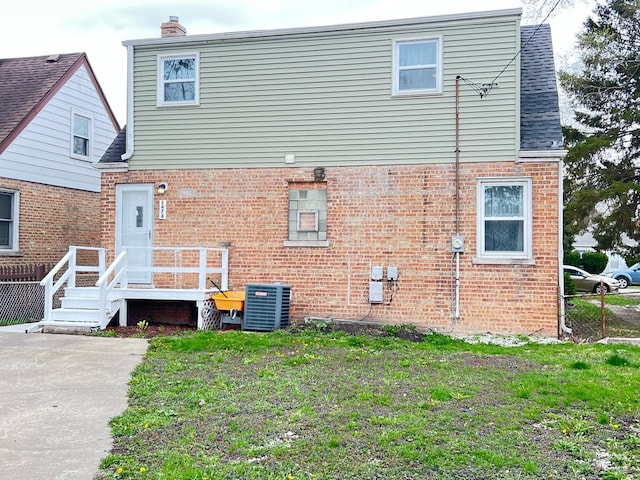 1474 Forest Ave, Calumet City, IL 60409 - rear view of house with brick siding, a chimney, and central AC