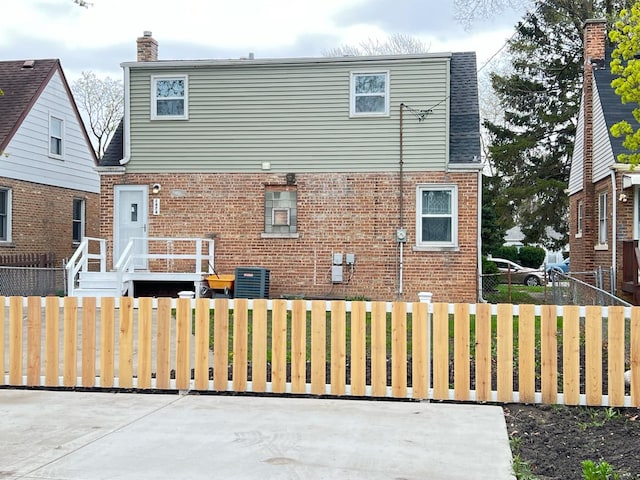 1474 Forest Ave, Calumet City, IL 60409 - rear view of house featuring brick siding, a chimney, and cooling unit