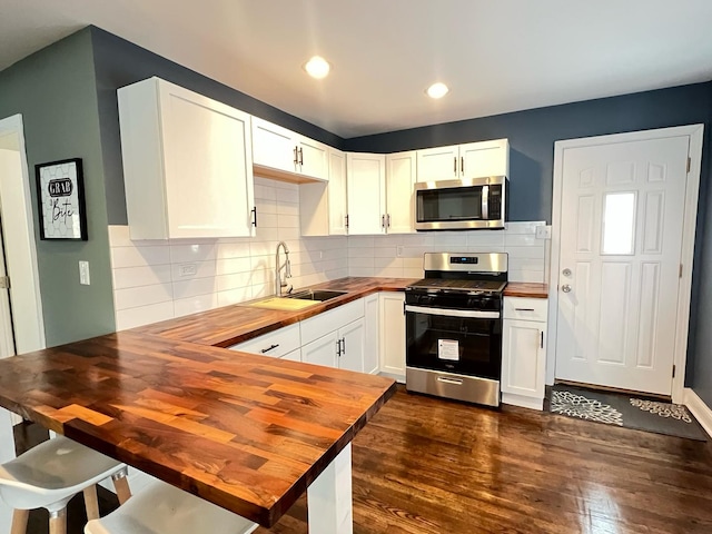 1474 Forest Ave, Calumet City, IL 60409 - kitchen featuring appliances with stainless steel finishes, butcher block countertops, dark wood finished floors, white cabinetry, and recessed lighting