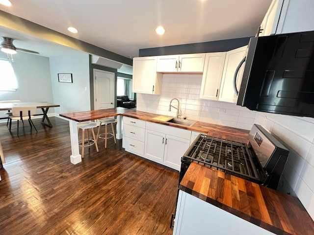1474 Forest Ave, Calumet City, IL 60409 - kitchen with butcher block countertops, a sink, black appliances, dark wood-type flooring, and recessed lighting