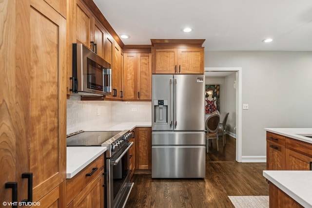 506 Westgate Rd, Deerfield, IL 60015 - kitchen with appliances with stainless steel finishes, backsplash, light countertops, brown cabinets, and dark wood-type flooring