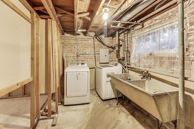 6636 S Rockwell St, Chicago, IL 60629 - below grade area featuring washing machine and clothes dryer, electric panel, and brick wall