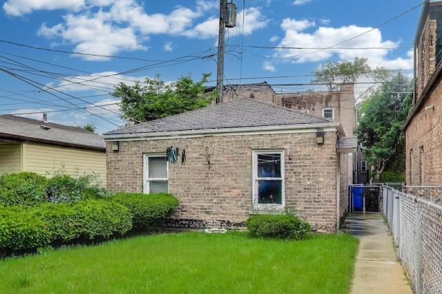 6636 S Rockwell St, Chicago, IL 60629 - rear view of house featuring brick siding and a shingled roof