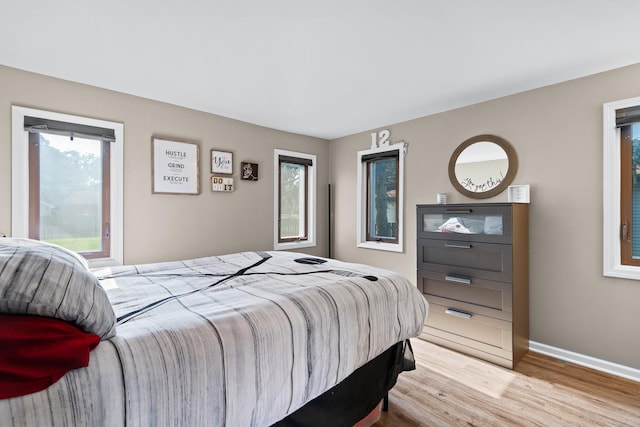 3050 Charles St, Melrose Park, IL 60164 - bedroom featuring multiple windows and wood finished floors