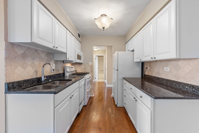 40 N Tower Rd Unit 14B, Oak Brook, IL 60523 - kitchen featuring white appliances, a sink, white cabinets, and decorative backsplash