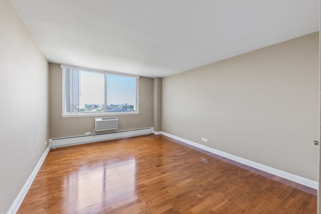40 N Tower Rd Unit 14B, Oak Brook, IL 60523 - empty room with wood finished floors, a baseboard radiator, baseboards, and a wall mounted AC