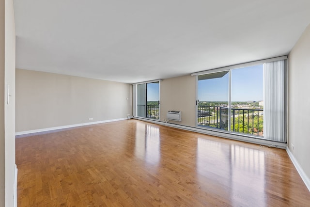 40 N Tower Rd Unit 14B, Oak Brook, IL 60523 - spare room featuring wood finished floors, a wall mounted air conditioner, and baseboards