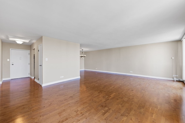 40 N Tower Rd Unit 14B, Oak Brook, IL 60523 - unfurnished living room featuring wood finished floors, a chandelier, and baseboards