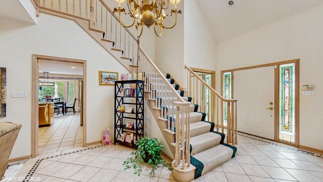 20195 Augusta Dr, Olympia Fields, IL 60461 - entryway featuring light tile patterned floors, high vaulted ceiling, stairway, a chandelier, and baseboards