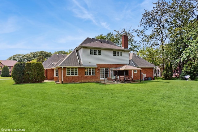 20195 Augusta Dr, Olympia Fields, IL 60461 - back of house featuring a patio, a chimney, brick siding, and a yard