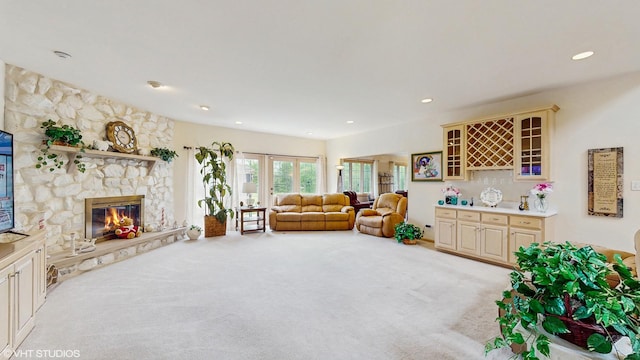 20195 Augusta Dr, Olympia Fields, IL 60461 - living room with light colored carpet, french doors, a stone fireplace, a bar, and recessed lighting