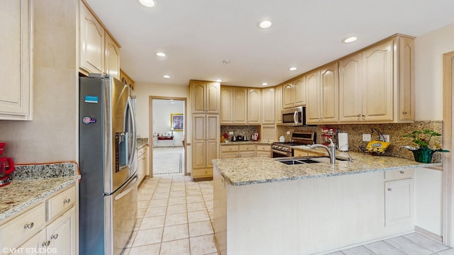 20195 Augusta Dr, Olympia Fields, IL 60461 - kitchen with stainless steel appliances, light brown cabinetry, a sink, a peninsula, and light stone counters