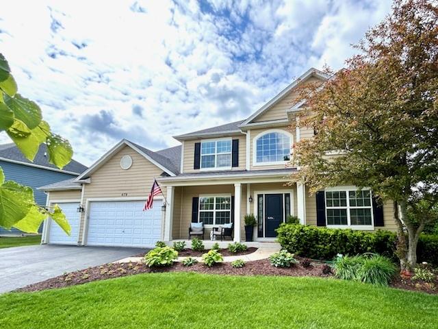 679 Slate Run, Elgin, IL 60124 - view of front of house featuring a porch, asphalt driveway, a front yard, and a garage