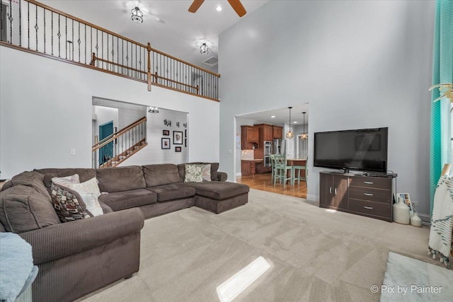 679 Slate Run, Elgin, IL 60124 - carpeted living room featuring a ceiling fan, a towering ceiling, stairway, baseboards, and recessed lighting