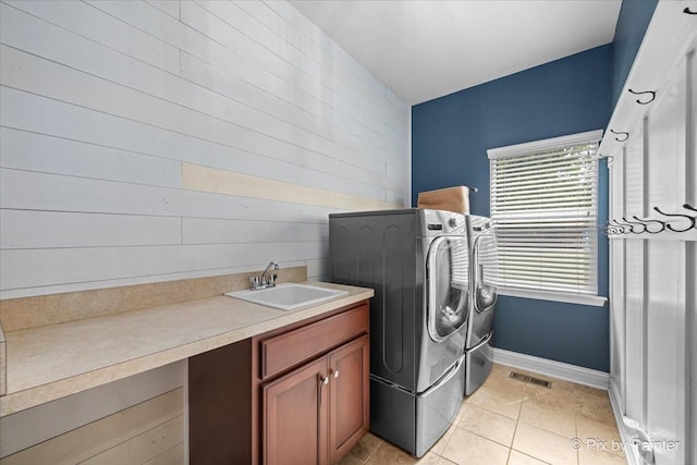 679 Slate Run, Elgin, IL 60124 - washroom with washing machine and dryer, light tile patterned flooring, wooden walls, cabinet space, and baseboards