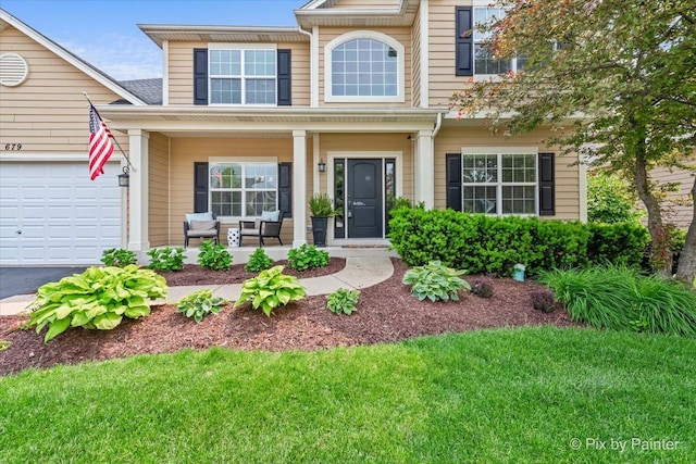 679 Slate Run, Elgin, IL 60124 - view of front facade featuring covered porch, a garage, and driveway
