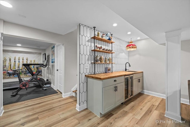 679 Slate Run, Elgin, IL 60124 - indoor wet bar with beverage cooler, light wood-type flooring, baseboards, recessed lighting, and decorative columns