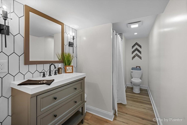 679 Slate Run, Elgin, IL 60124 - full bathroom with vanity, wood finished floors, toilet, baseboards, and a shower with shower curtain