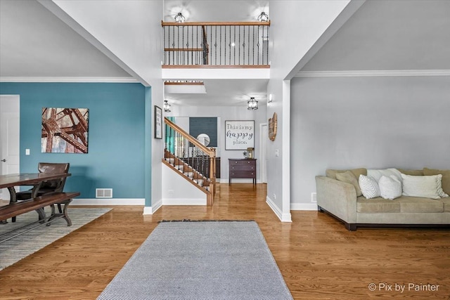679 Slate Run, Elgin, IL 60124 - entryway featuring stairs, baseboards, crown molding, wood finished floors, and a towering ceiling
