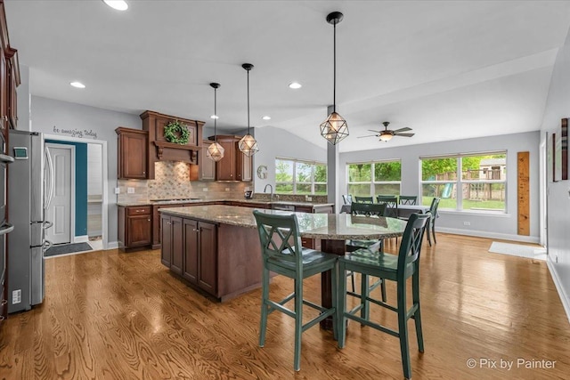 679 Slate Run, Elgin, IL 60124 - kitchen with wood finished floors, healthy amount of natural light, vaulted ceiling, decorative backsplash, and ceiling fan