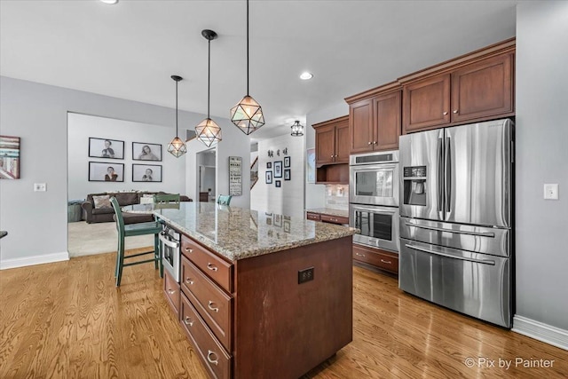 679 Slate Run, Elgin, IL 60124 - kitchen with appliances with stainless steel finishes, light wood-style flooring, a kitchen island, baseboards, and recessed lighting