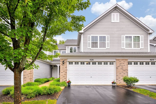 426 Victoria Ln Unit 426, Elgin, IL 60124 - traditional-style home with brick siding, asphalt driveway, and a garage