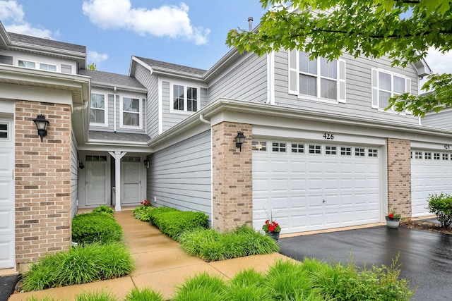 426 Victoria Ln Unit 426, Elgin, IL 60124 - traditional-style house with brick siding, a garage, and asphalt driveway