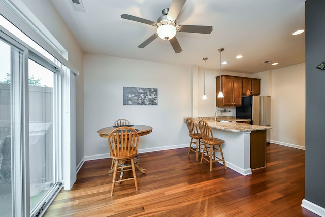 426 Victoria Ln Unit 426, Elgin, IL 60124 - kitchen with ceiling fan, dark wood finished floors, a peninsula, a breakfast bar area, and recessed lighting