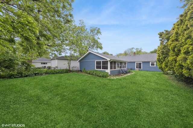 349 N Garfield St, Lombard, IL 60148 - rear view of property with a sunroom, a chimney, and a lawn