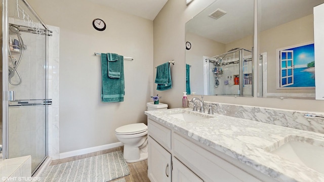 2080 Maplewood Cir, Naperville, IL 60563 - full bathroom featuring double vanity, wood finished floors, a shower stall, toilet, and baseboards
