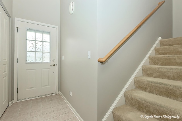 2704 Kendall Xing Unit 2704, Johnsburg, IL 60051 - doorway with stairway, baseboards, and light tile patterned floors