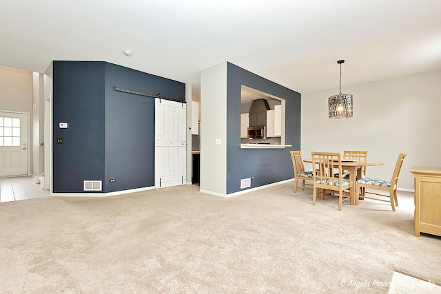 2704 Kendall Xing Unit 2704, Johnsburg, IL 60051 - dining space featuring light carpet, baseboards, a chandelier, and a barn door