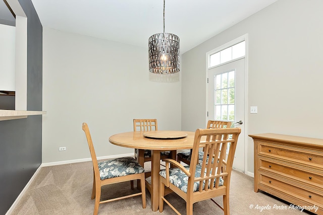 2704 Kendall Xing Unit 2704, Johnsburg, IL 60051 - dining space with light colored carpet, a chandelier, and baseboards