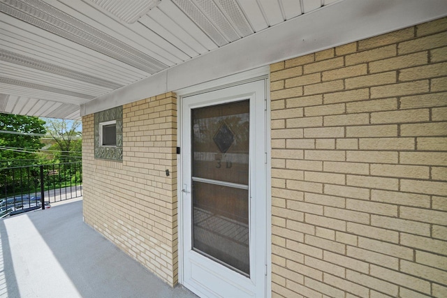 6534 N NW Hwy Unit 3D, Chicago, IL 60631 - doorway to property featuring brick siding and a balcony