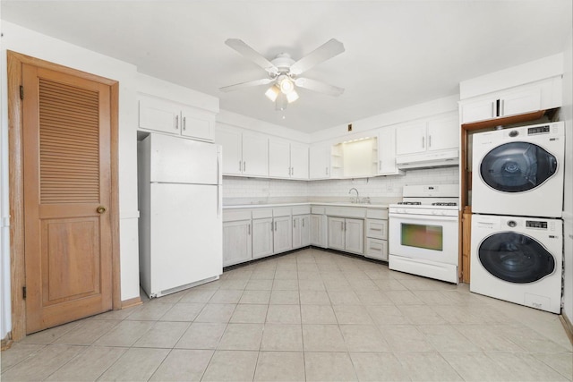 6534 N NW Hwy Unit 3D, Chicago, IL 60631 - kitchen with white appliances, stacked washing machine and dryer, under cabinet range hood, a sink, and decorative backsplash