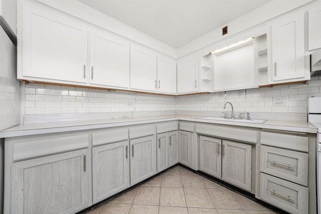 6534 N NW Hwy Unit 3D, Chicago, IL 60631 - kitchen with open shelves, a sink, light countertops, backsplash, and light tile patterned flooring